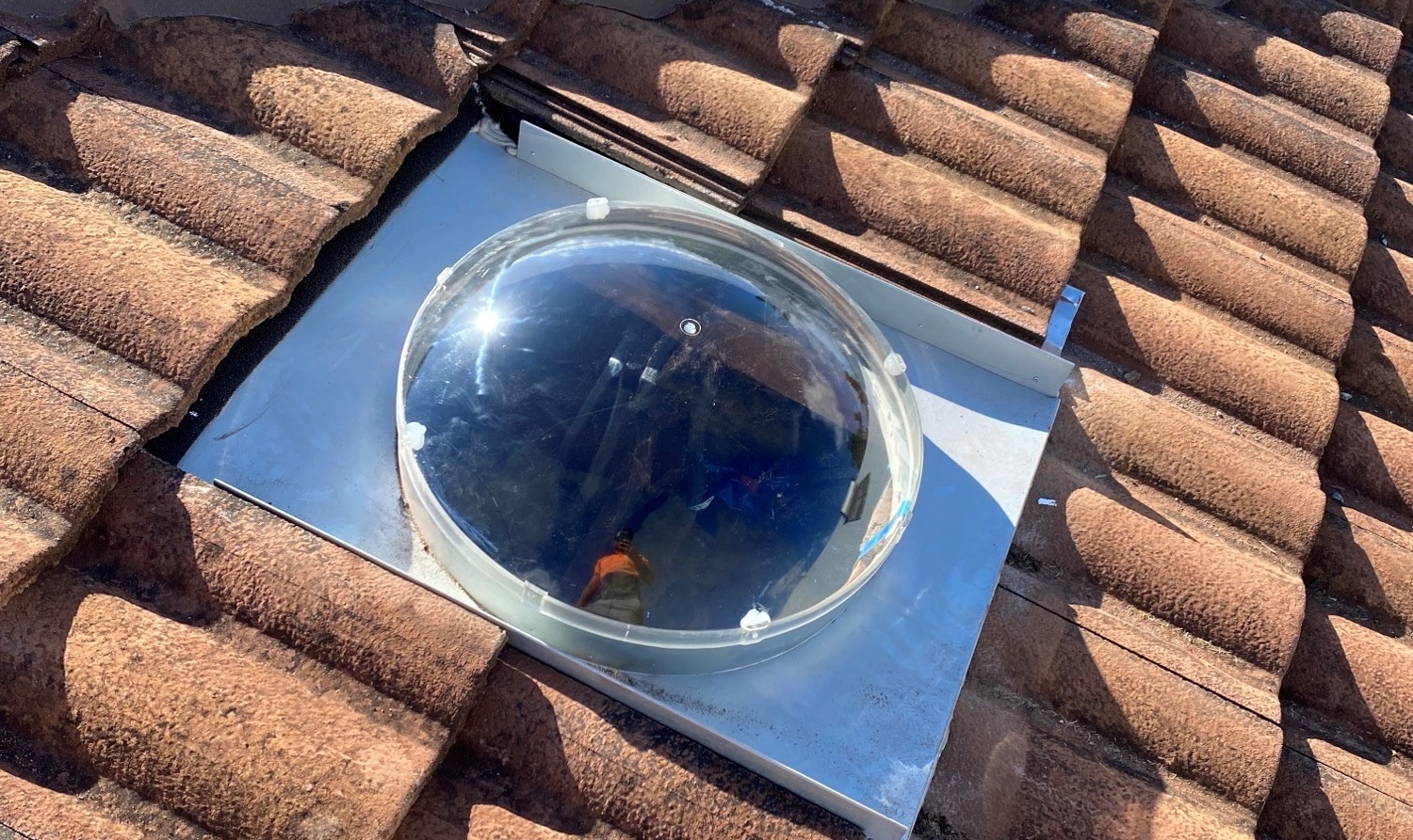 round skylight dome on tiled roof